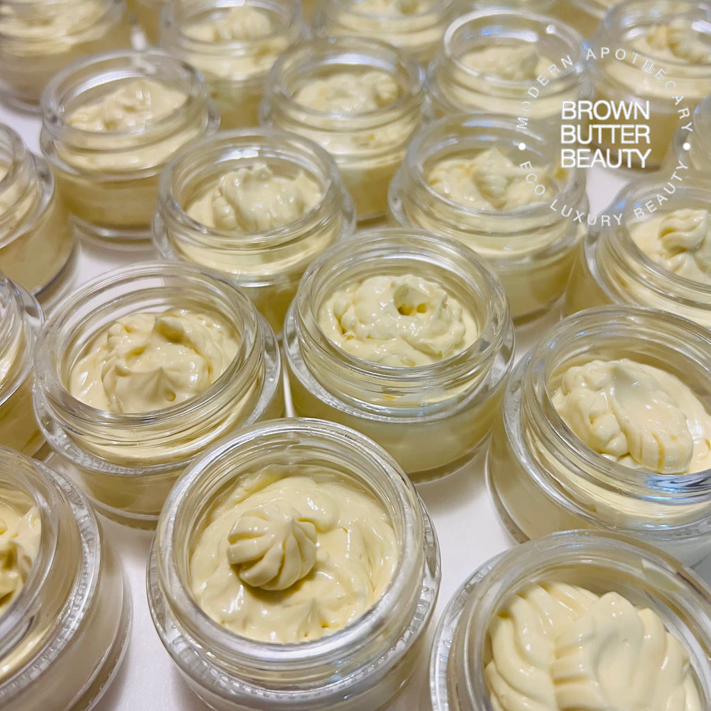 Multiple jars of handmade calendula face cream in production, each filled with rich, textured cream and arranged neatly on a clean surface. This artisanal calendula cream highlights the natural, botanical ingredients and careful craftsmanship used to create high-quality skincare for soothing and nourishing sensitive skin